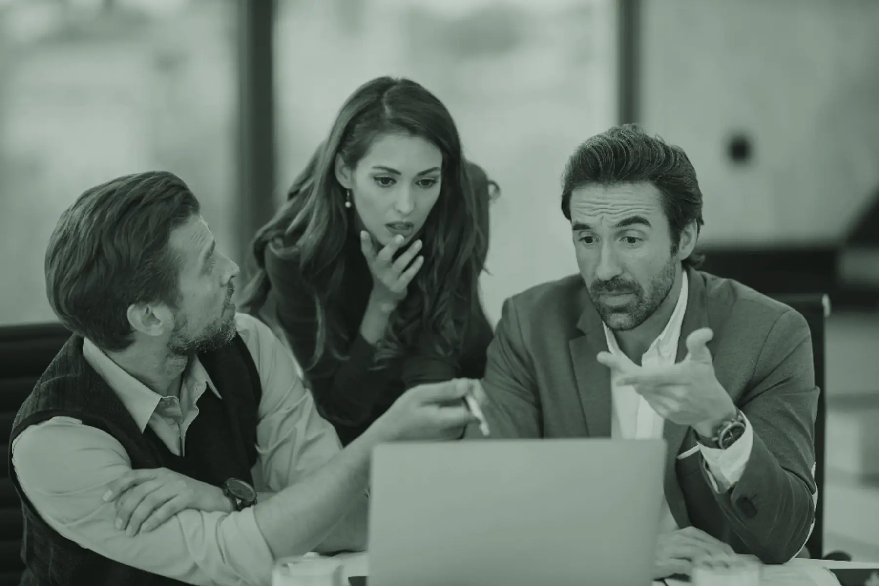 Advisers in discussion around a laptop